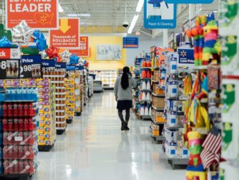 woman walks inside grocery store