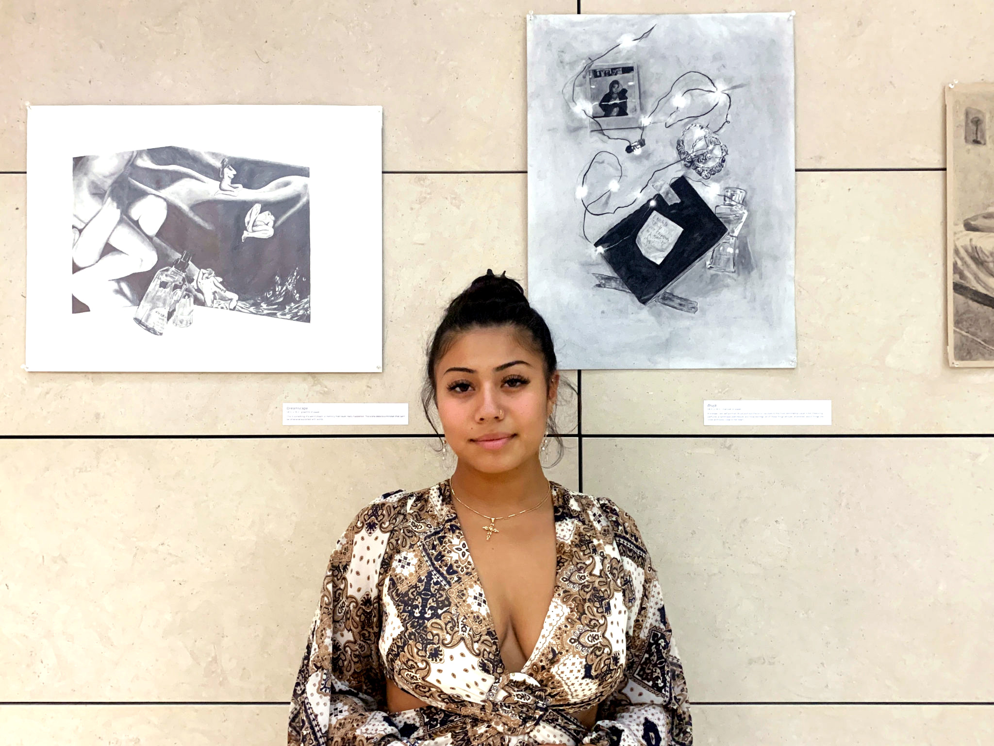 Karina Arenas '23 poses in front of her artwork in William Hannon Library.