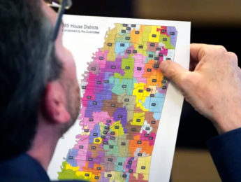 Rep. Dan Eubanks, a Republican in the Mississippi state House of Representatives, examines a copy of the House redistricting map. Associated Press: Rogelio V. Solis