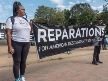 Supporters holding sign for reparations