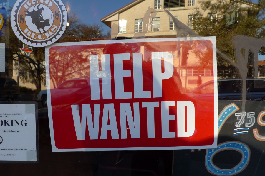 Help Wanted sign in window of business