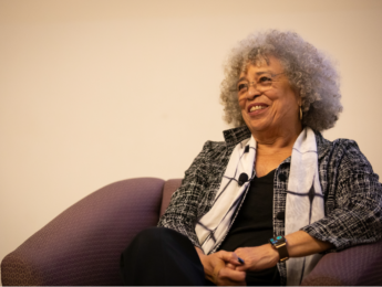 A close up photo of Angela Davis seated in the Life Science Building auditorium.