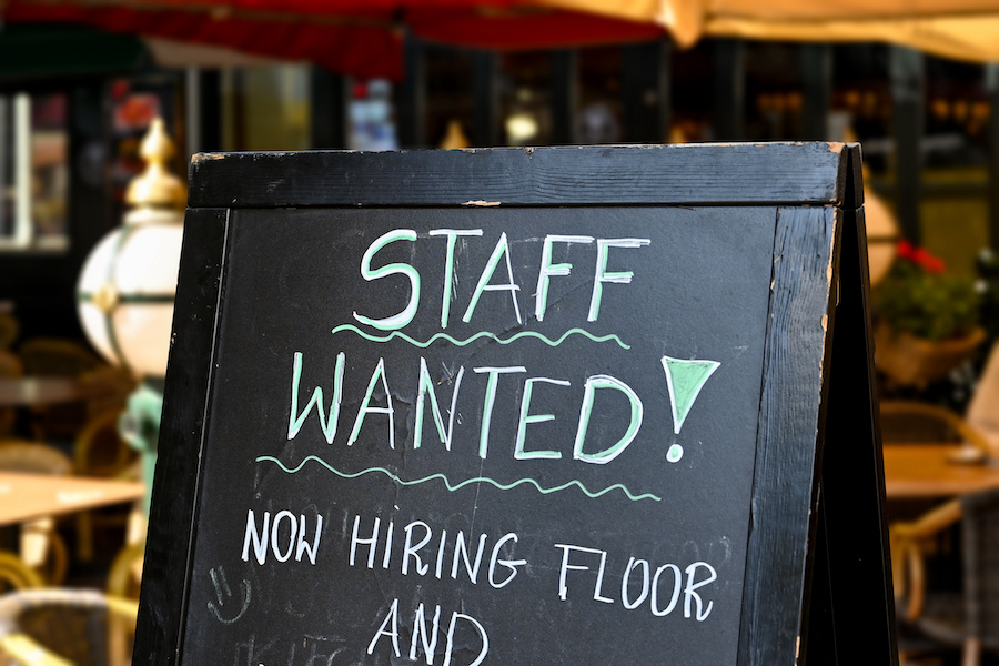Staff wanted recruitment sign outside a restaurant in Europe