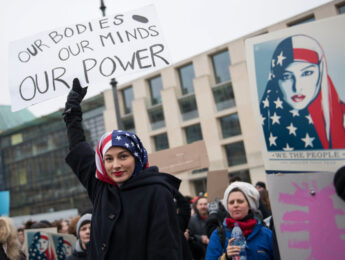 Image of woman holding a sign at a protest