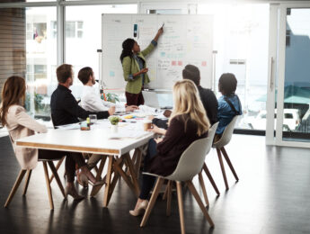 Shot of a businesswoman giving a presentation to her colleagues on a whiteboard in a boardroom