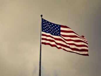 American flag flies against dark sky