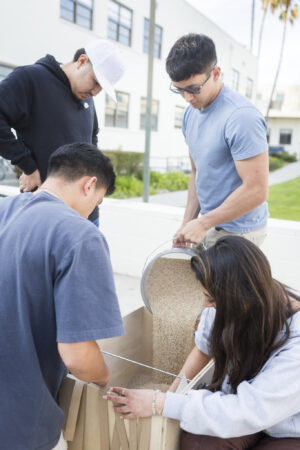 LMU's GeoWall team members build their project.