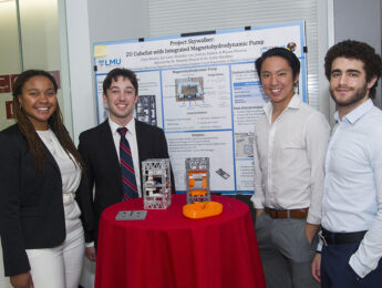 Students at the 2023 Engineering Design Showcase display their cubesat project.