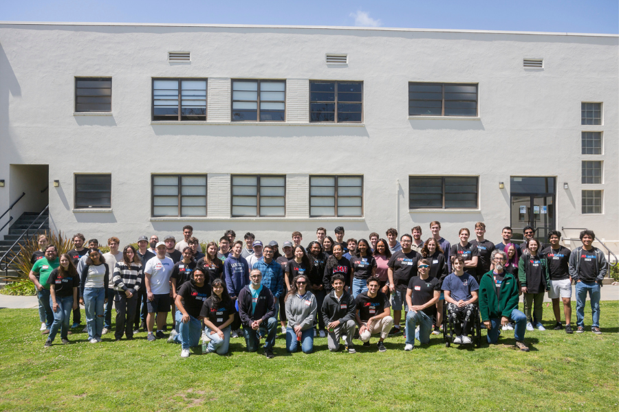 The participants of LMU's 2023 Hackathon gather for a picture on the lawn behind Pereira Hall.
