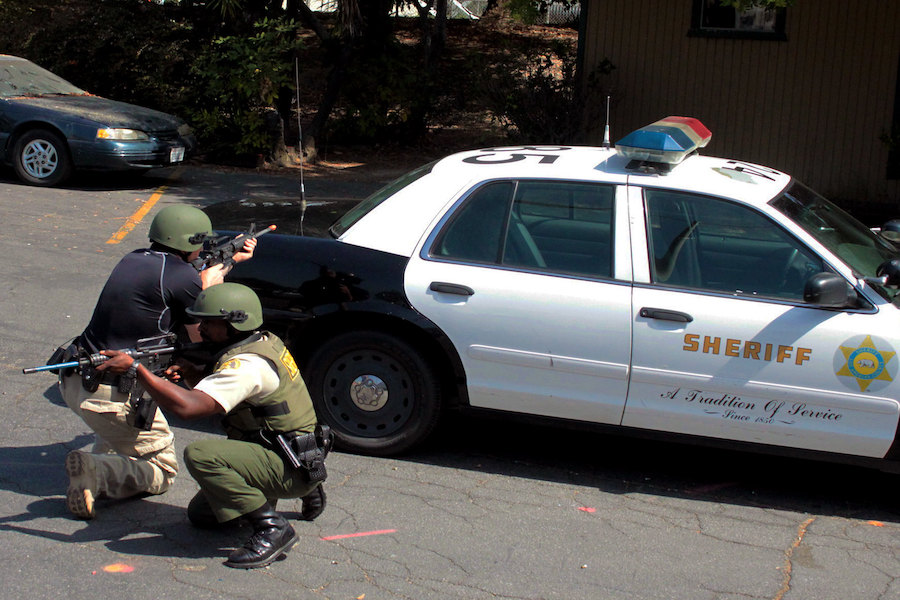 L.A. Sheriffs in training exercise with vehicle in background
