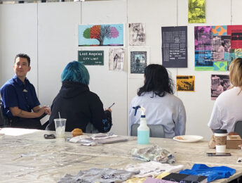 Barhaugh-Bordas (far left) listens as printmaking student engage in self-critique during class.
