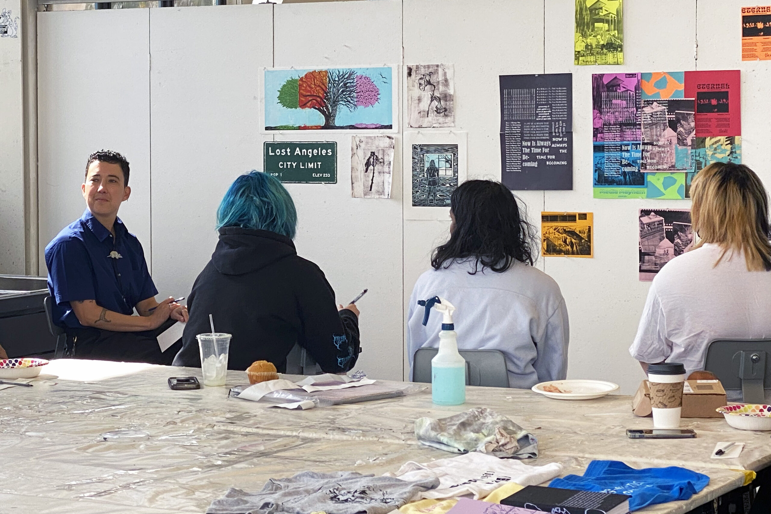 Barhaugh-Bordas (far left) listens as printmaking student engage in self-critique during class.