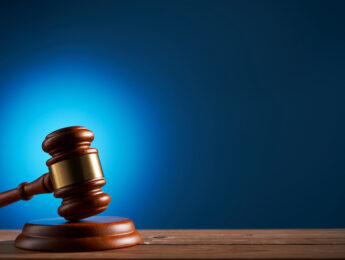gavel hammer against blue background with copy space