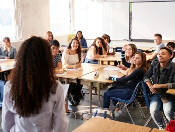 picture of high school teacher and students in a classroom