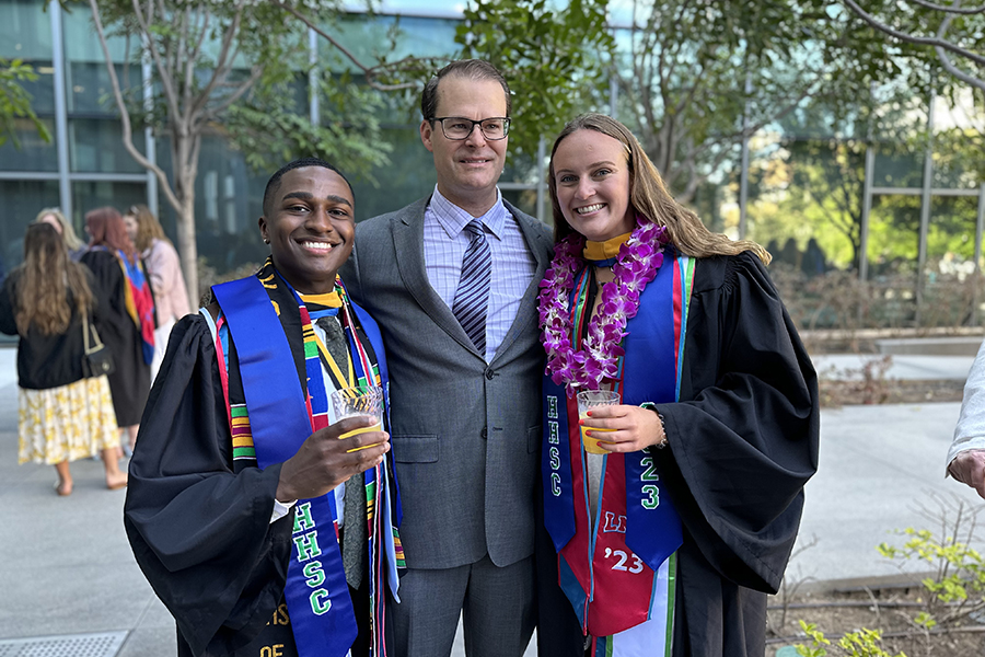 Department Chair Professor Shoepe poses with two HHSC graduates