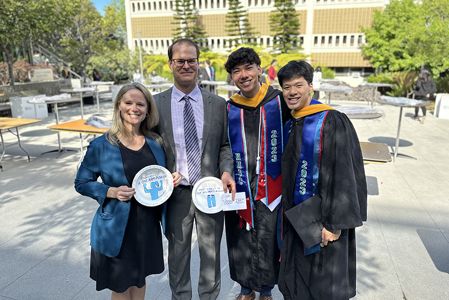 Two HHSC professors pose with two HHSC graduates