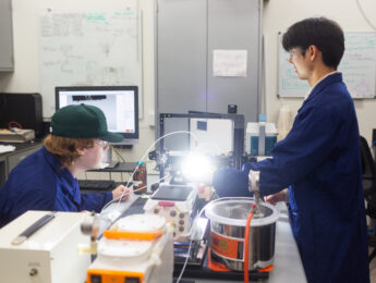Two students work in an engineering lab