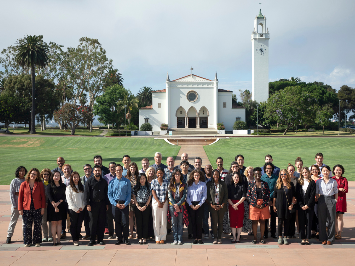 A group of new LMU faculty gather for a picture in front of Sacred Heart Chapel.