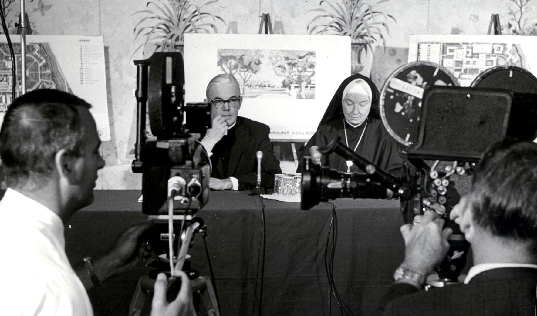 A black and white photo from the press conference in 1973 about the merger of Loyola and Marymount.