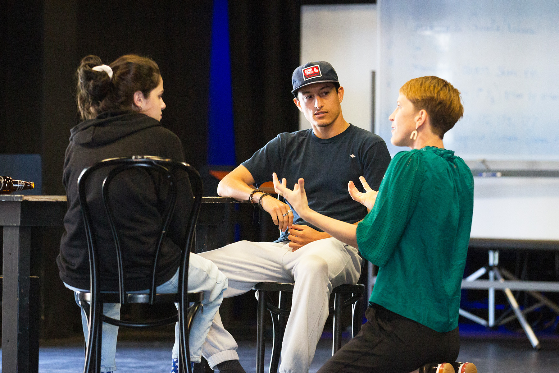 Professor instructs students in theatre space