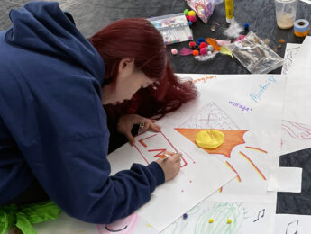 A student engages in art therapy in the dance classroom