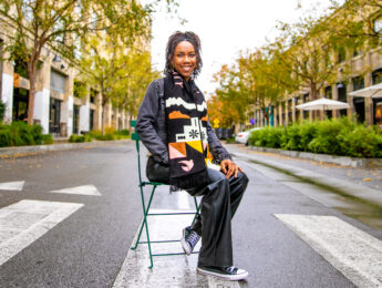 A young woman sits in a chair in a crosswalk